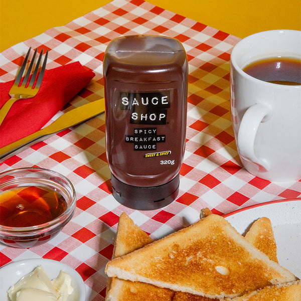 Sauce Shop Spicy Breakfast Sauce on chequered table cloth with tea, toast and maple syrup