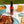 A bottle of Sauce Shop Original Hot Sauce on a picnic table surrounded by nachos, BBQ spatchcock chicken and beer