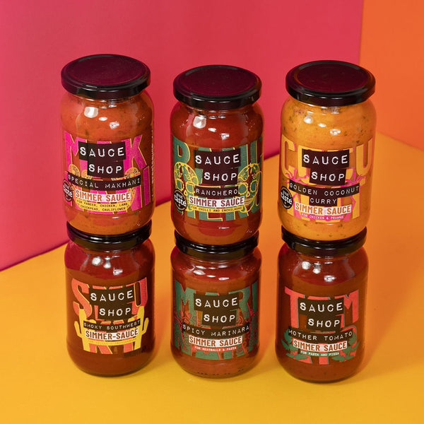 Stacked jars of Sauce Shop Simmer Sauces including Special Makhani, Ranchero, Golden Coconut Curry, Smoky Southwest, Spicy Marinara, Mother Tomato on a yellow, pink and orange background