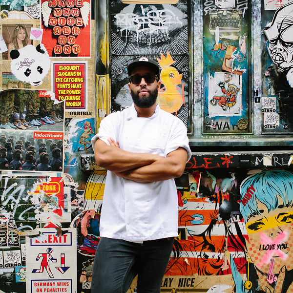 Chef James Cochran in front of graffiti wall